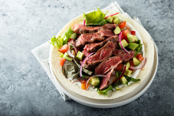 Beef steak fajitas with avocado and onion