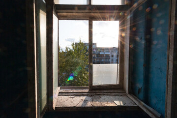 the open window of an abandoned house