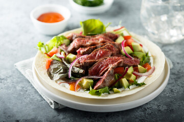 Beef steak fajitas with avocado and onion