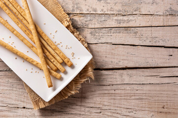Breadstick grissini snack on rustic wooden table.Copy space	
