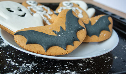 Halloween party, cookies with pumpkin, ghost, bat icing. Handmade in the bakery. View from above.