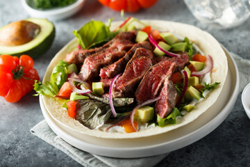 Beef steak fajitas with avocado and onion