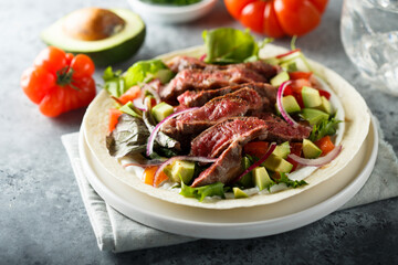 Beef steak fajitas with avocado and onion