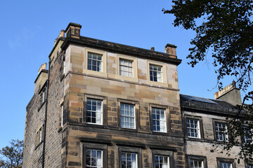 Fototapeta na wymiar Stone Facade of Old Victorian Building against Blue Sky 