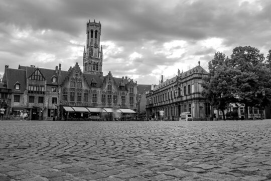 Long exposure black and white photograph of a square with granite pavement in the old center of Bruges, Belgium