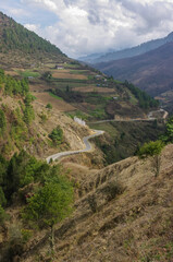 Scenic mountain landscape view with winding road in the beautiful high Phobjikha valley in Central Bhutan