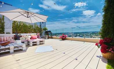 cute, cozy pallet furniture with colorful pillows at rooftop summer patio, lounge outdoor space