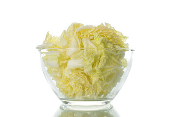 Chopped Chinese cabbage in a glass dish, close-up, isolated on white.