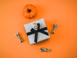 Gift, pumpkin and skull with bones on ornamentation.