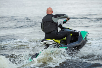 man running the wave on jet ski during summer vacation