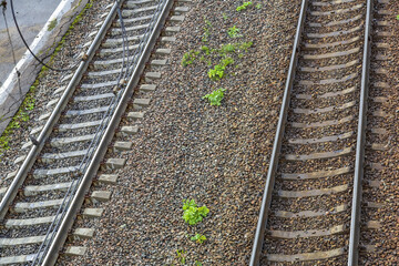 Fototapeta premium Part of the railroad track at the train station. Rails, sleepers, pebbles