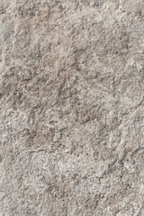 Empty rough, uneven texture of a gray concrete wall close up with copy space.