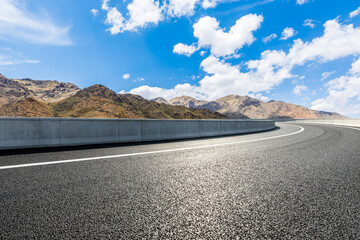 Highway ground and mountain natural scenery under blue sky.Landscape and highway.Outdoor road background.