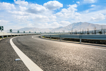 Naklejka premium Highway ground and mountain natural scenery under blue sky.Landscape and highway.Outdoor road background.