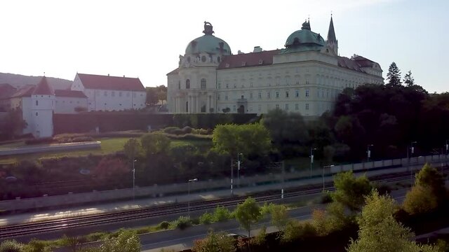 Ascending flight with an Aerial view of the Klosterneuburg Monastery, Lower Austria during sunset.