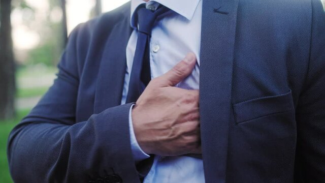 Man in business suit holding chest, feeling sharp heart pain, heart failure