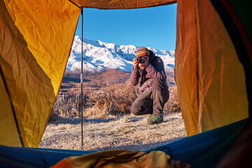 Tent lookout on a Camp in the mountains. view from tent camping entrance outdoor. Travel Lifestyle concept adventure vacations outdoor.