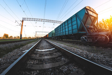 Freight train in the background of sunset - dawn is waiting for departure to its destination