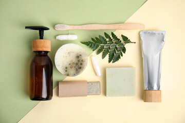 Eco friendly personal care products and green leaf on color background, flat lay