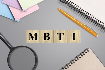 Blank letters on wooden dices cubes on the desk with stationery. Psychological test concept.
