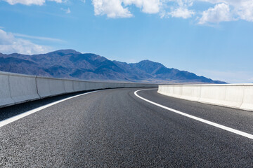 Highway ground and mountain natural scenery under blue sky.Landscape and highway.Outdoor road background.