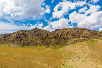 Xinjiang grassland and mountain scenery in autumn season,China.