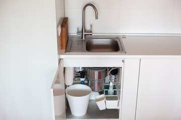 Modern kitchen organization. Drawer under the sink. Convenient storage. Food waste disposer. Zero waste.