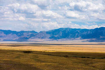 Xinjiang grassland and mountain scenery in autumn season,China.