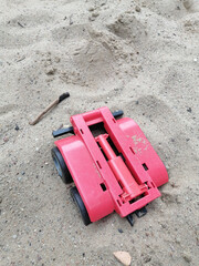 Closeup shot of a toy car on the sand