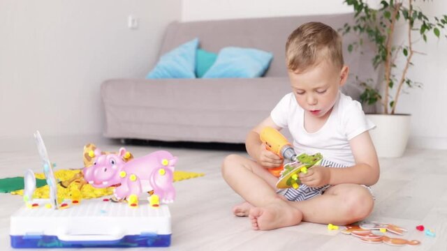 a boy child is playing educational games at home fooling around and smiling