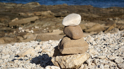 Fototapeta na wymiar Rocks piled up (a cairn) on the shore in Hawaii 