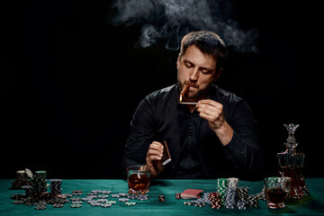 Bearded casino player man playing poker on green table