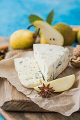 Gorgonzola picant Italian blue cheese, made from unskimmed cow's milk in North of Italy. Piece of blue mould cheese danablu,  roquefort with pear and walnuts