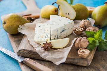 Gorgonzola picant Italian blue cheese, made from unskimmed cow's milk in North of Italy. Piece of blue mould cheese danablu,  roquefort with pear and walnuts