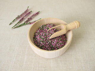 Dried flowers from heather herb in a wooden bowl - obrazy, fototapety, plakaty