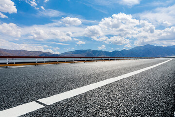 Fototapeta premium Highway ground and mountain natural scenery under blue sky.Landscape and highway.Outdoor road background.