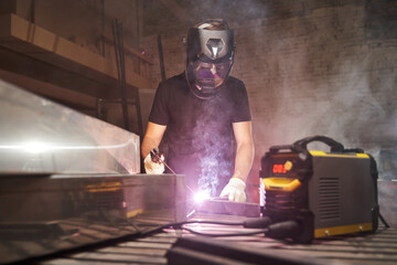 welding process. a welder in a helmet at work