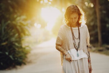 Woman walking in the summer sunset light