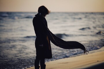 Woman walking on the winter beach
