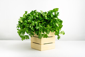 A wooden box full of green fresh parsley.