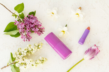 Woman perfume and flowers on the white background.