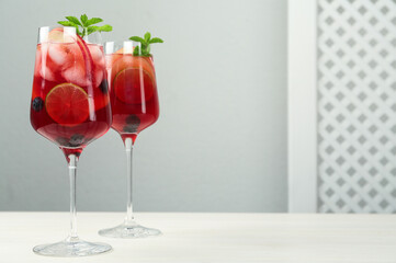 Delicious Red Sangria with fruits on white wooden table, space for text