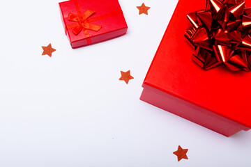 Composition of red presents with stars and copy space on white background