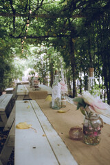 wooden tables laid with wedding decorations