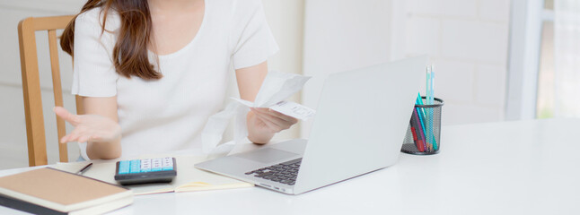 Young asian woman calculating expenses household about finance and frustrated on desk at home, girl...
