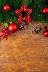Fototapeta na wymiar Composition of christmas decorations with fir tree, baubles and copy space on wooden background