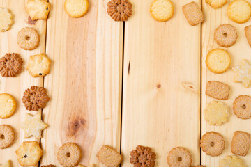 Composition of christmas cookies and copy space on wooden background