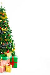 Composition of christmas tree with decorations, presents and copy space on white background