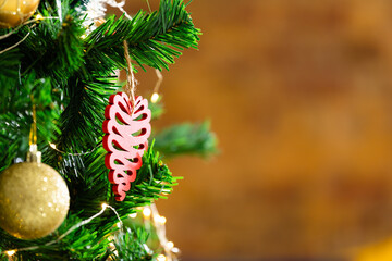 Composition of christmas tree with gold baubles and decorations on blurred background