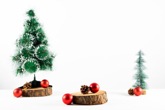 Composition of christmas decorations with fir trees and baubles on white background
